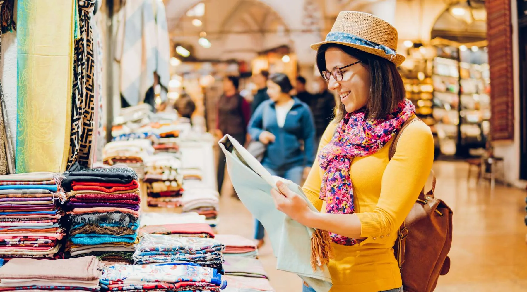 Woman looking at fabric in bazaar